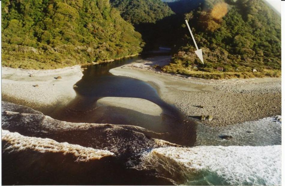 The hut (arrowed), beside the Gorge River. Photos supplied.