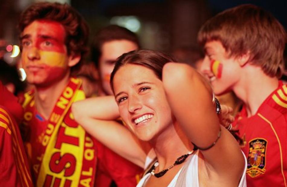 Fans react after Spain scored during the World Cup round of 16 soccer match between Spain and...