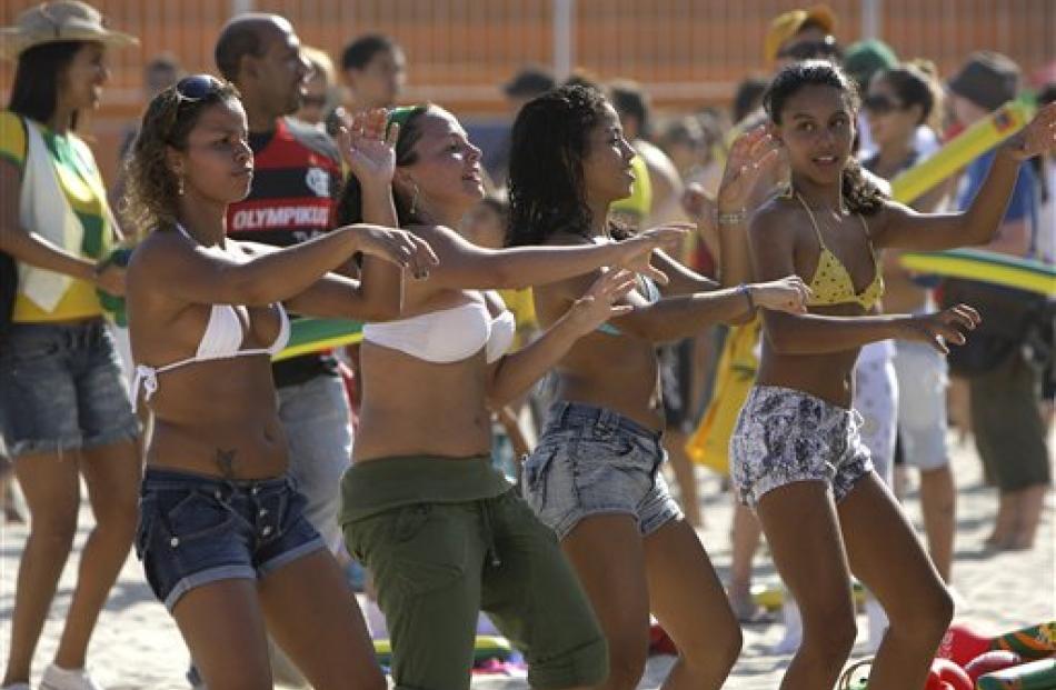 Fans of Brazil's football team dance before the World Cup 2010 soccer match between Brazil and...