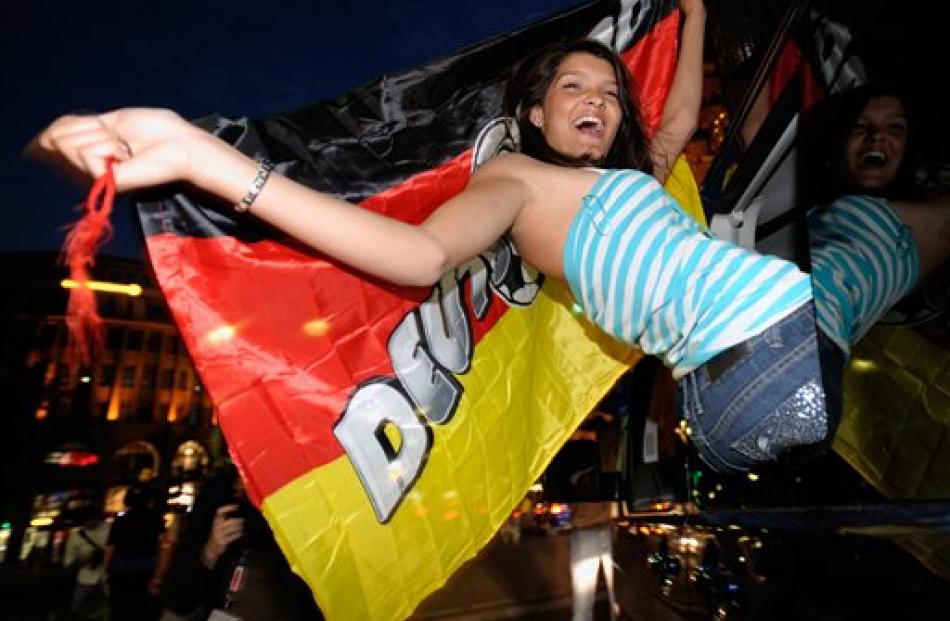 A German fans celebrates a win in Berlin. (AP Photo/Jens Schlueter)