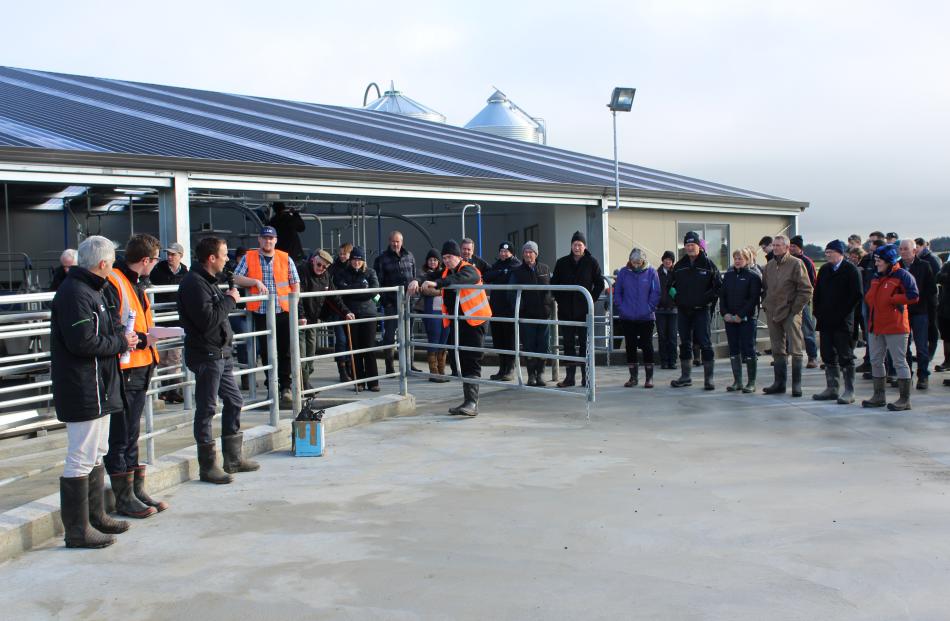 Southland Farm Services operations manager Mark McMillan, talks to visitors at the Southern Dairy Hub with DairyNZ consulting officer Nathan Nelson (second from left) and DairyNZ scientist Paul Edwards (left) about the milking shed at the hub.