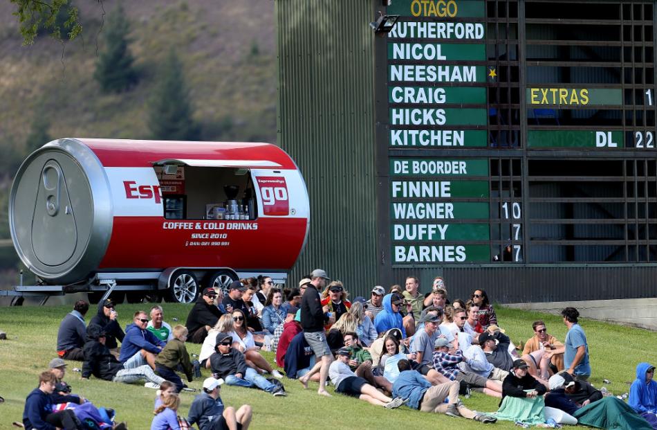 Supporters relax in the sun at Molyneux Park for the Twenty20 Supersmash match between Otago and Canterbury yesterday. 