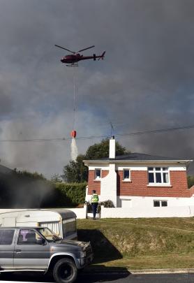 A helicopter puts out a fire on a Mulford St property.