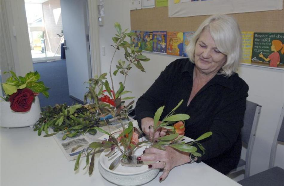 Alison Rowe, of Dunedin, works on her arrangement.