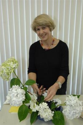 Charlotte Morris works on an ikebana arrangement. Photos by Linda Robertson.