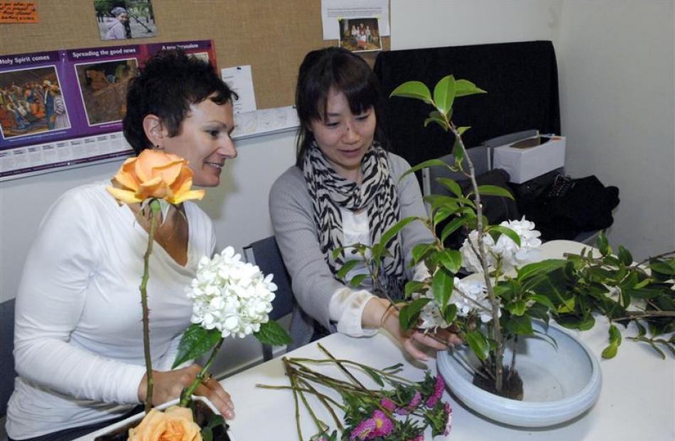 Iby Virag, of Dunedin (left), and Katsuko Hanada, from Otaru, take part in an ikebana class at...