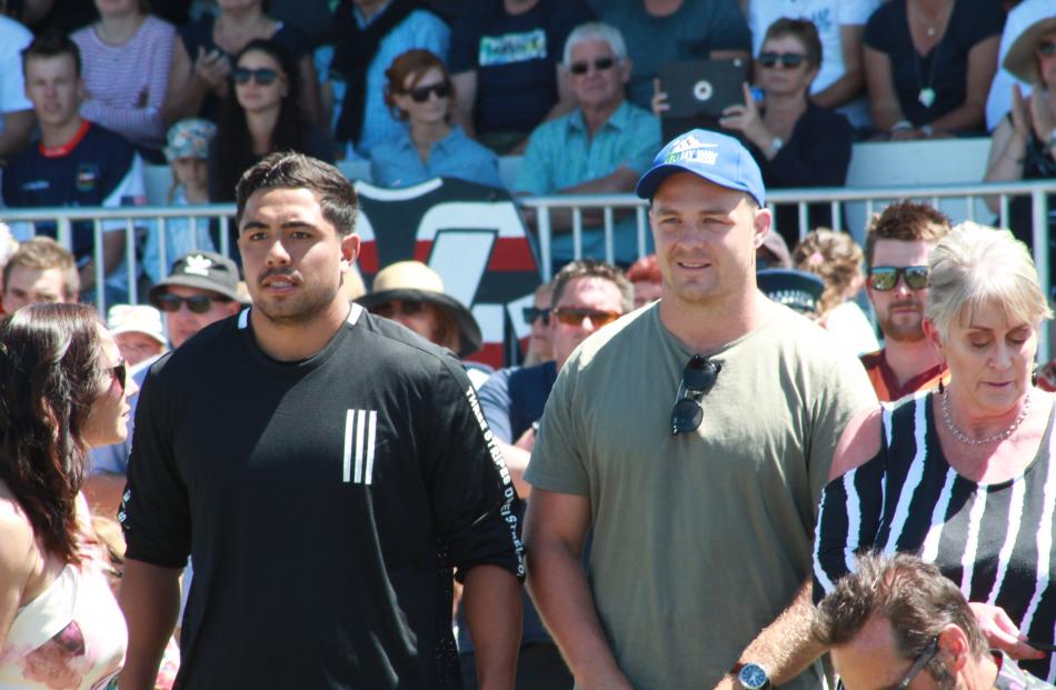 All Blacks players (from left) Anton Lienert-Brown and Sam Kane watch on from the sidelines.