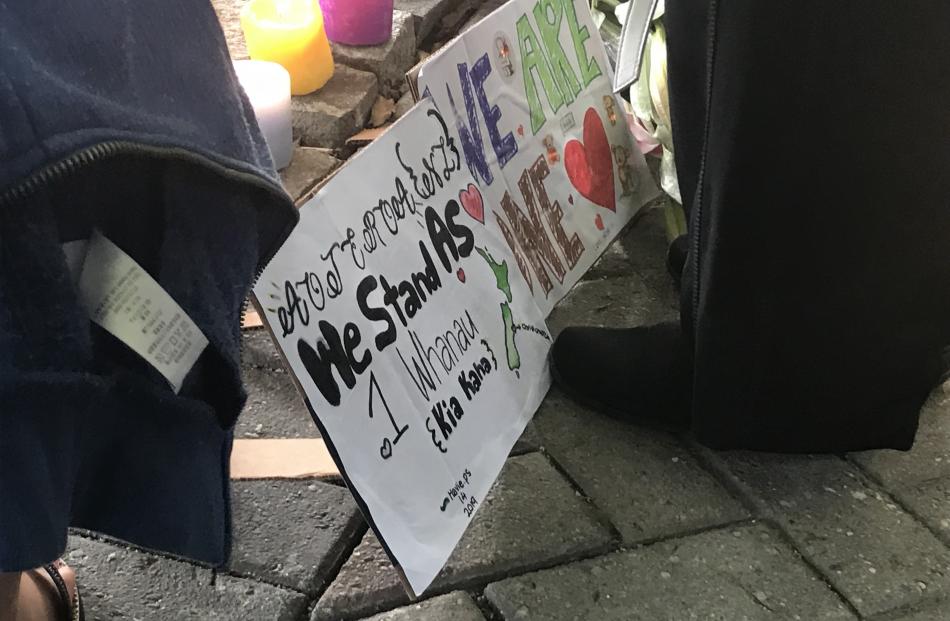 Placards with words of unity and solidarity were on display at the vigil. Photo: Daisy Hudson
