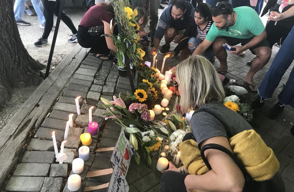 Flowers and candles have been laid out as a tribute to the victims of the Christchurch mosque shootings. Photo: Daisy Hudson
