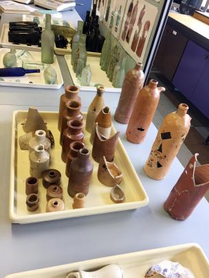 Clay bottles, assorted metal artefacts, and pipes and tobacco boxes were among the remnants of...