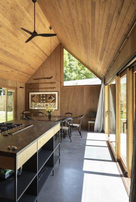 Open shelving features in the kitchen and a framed tapa, in the dining area.