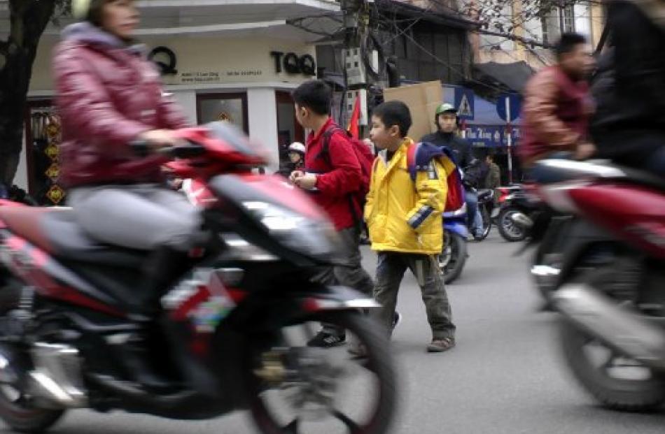 Crossing the street in Hanoi's Old Quarter  is adventure tourism at its most risky. Photos by D....