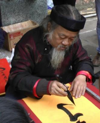 People queue to have bearded calligraphers inscribe traditional "parallel sentences".
