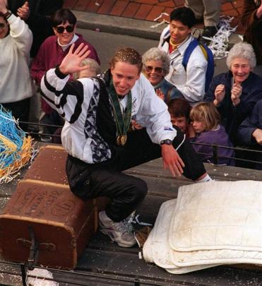 Double swimming gold medallist Danyon Loader waves to the crowd during his Dunedin parade in 1996.