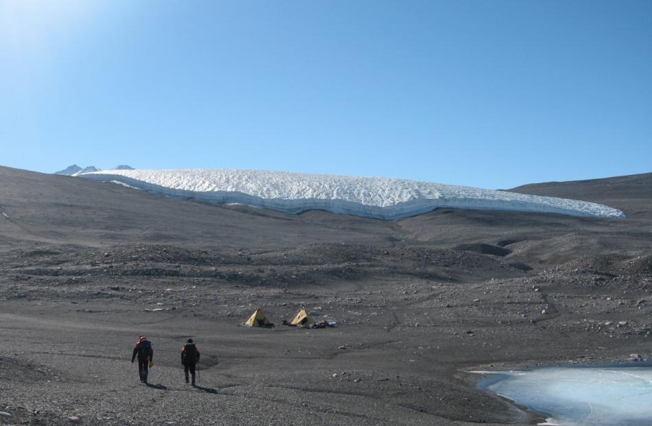 A photo shows geologists walking towards their campsite in Walcott Bay, in the Antarctic. PHOTO:...