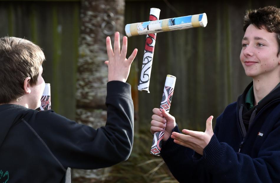 Strath Taieri School pupils (from left) Henry Hope (10) and Shay Lindsay (13) pass rakau sticks...