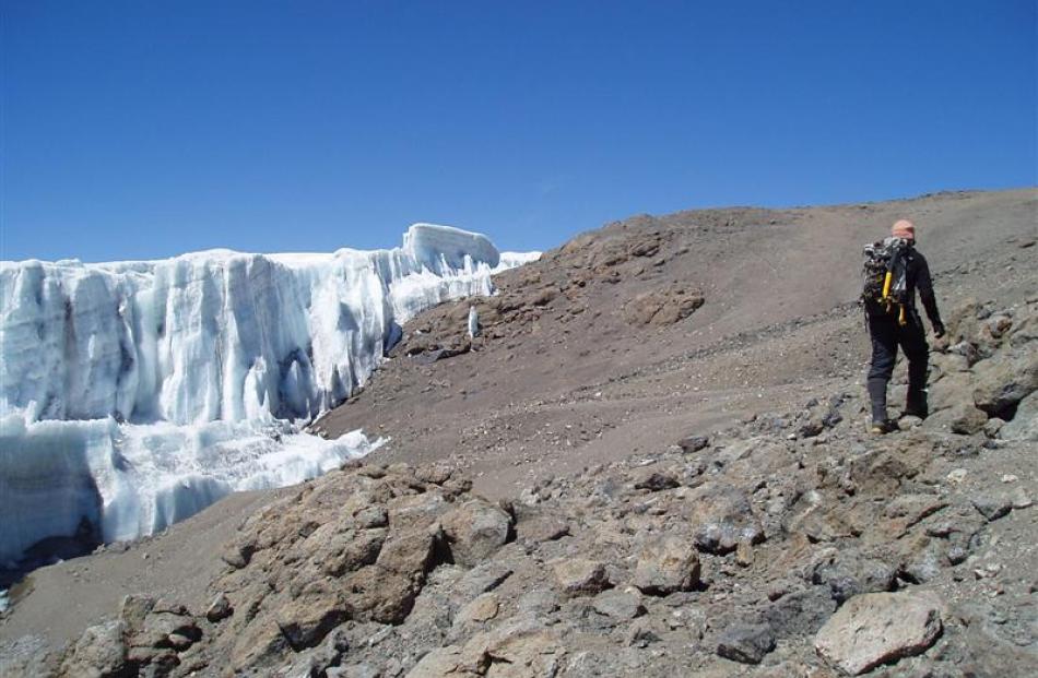 Dr Cullen climbs a rocky section of Mt Kilimanjaro.