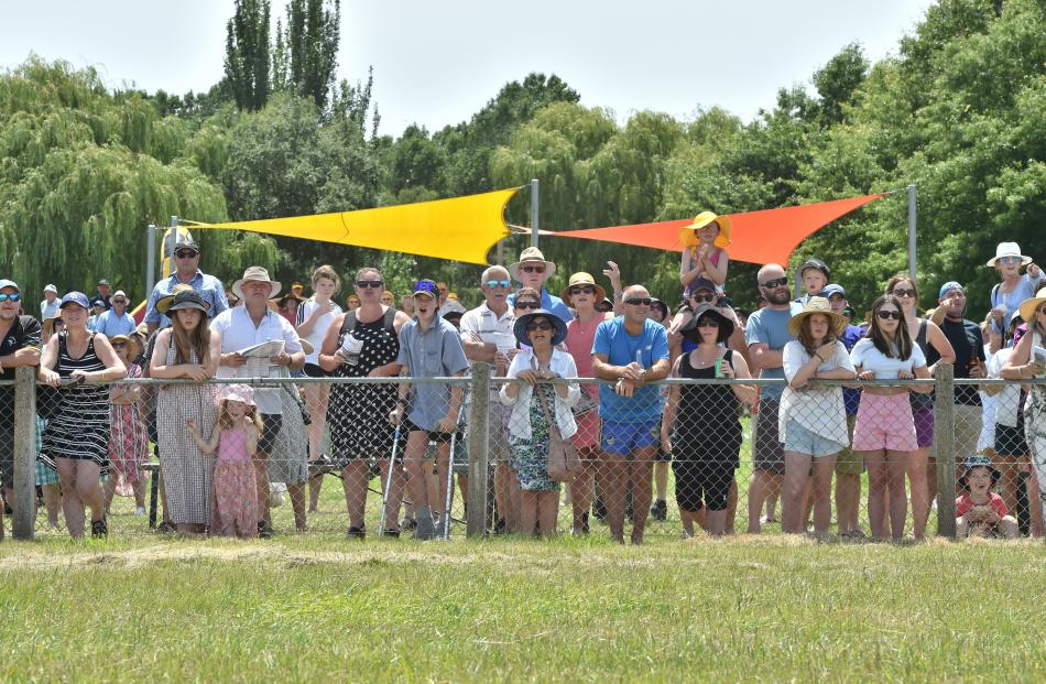 The crowd cheers on runners in the second race.