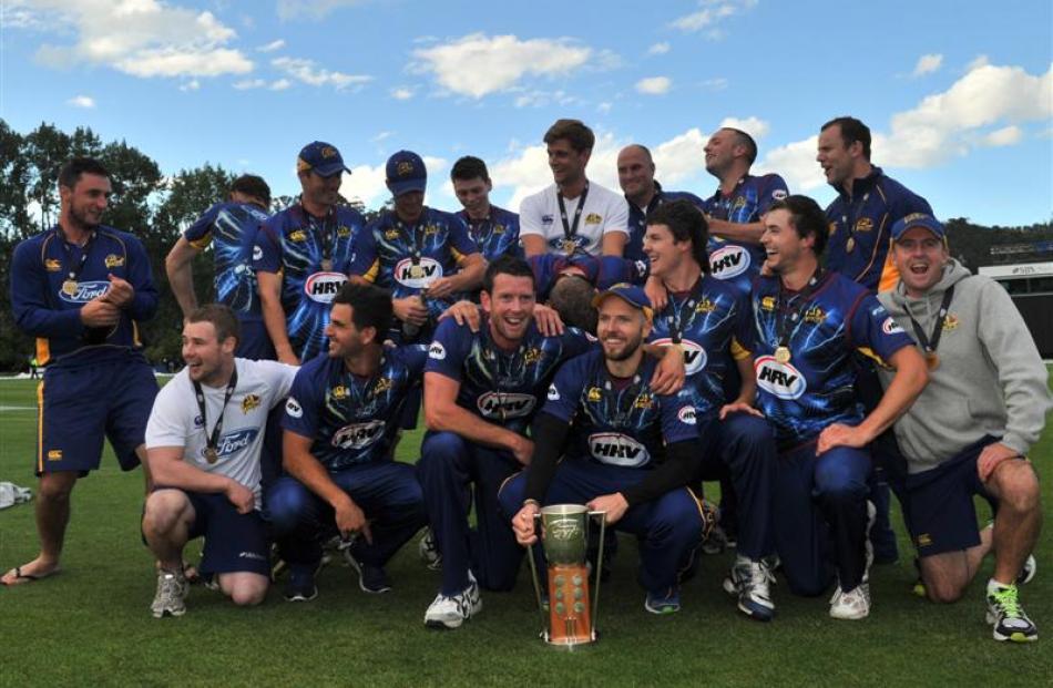 Otago Volts players and management celebrate their HRV Cup title at the University Oval in January.