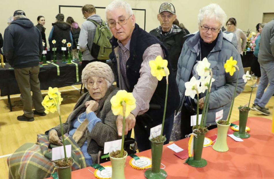 Phyllis Sheppard is accompanied by her nephew Brendan Harris as they look over the top blooms on...