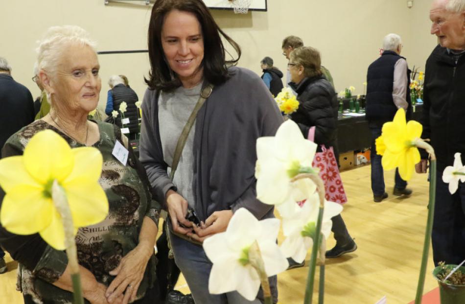 The President of the Woodend Spring Flower Show Shirley Wheeler  (left) looks over the champion...