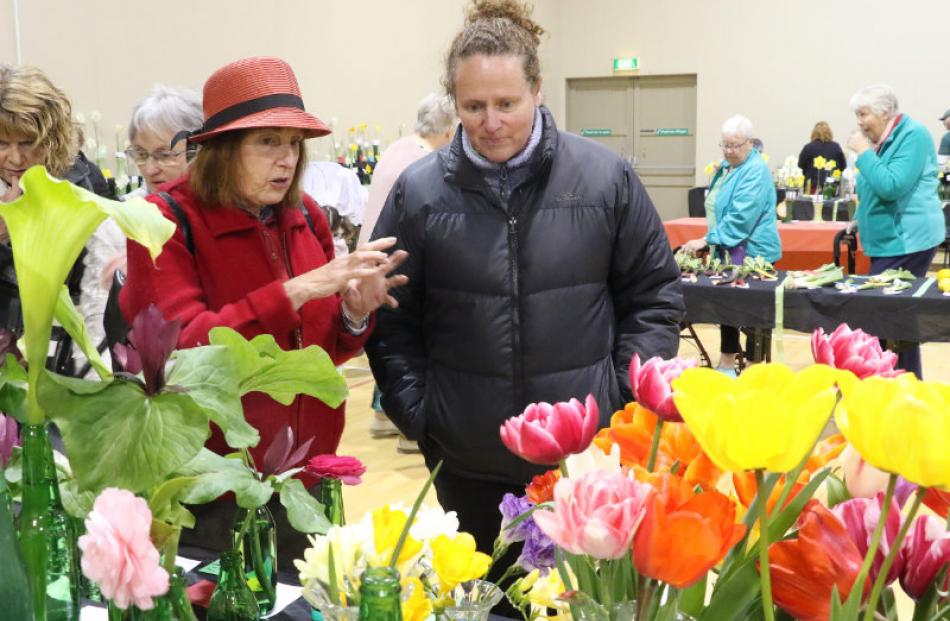 Sherri Hirtzel left, and her daughter Julie Planner look over the cut flowers at the  89th annual...