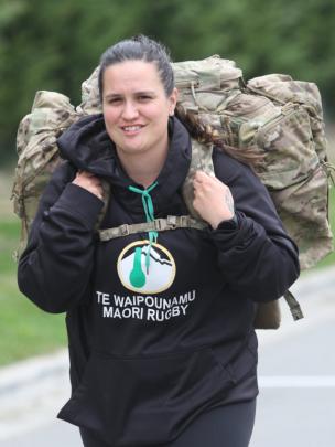 Heavy load . . .Tiana Milner  walks yet another round of the pack march circuit 24 hours into the...