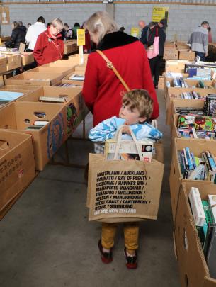 Fully loaded . . . With his bag full, Harry Sinnott 7, joins the queue for the checkout at the...