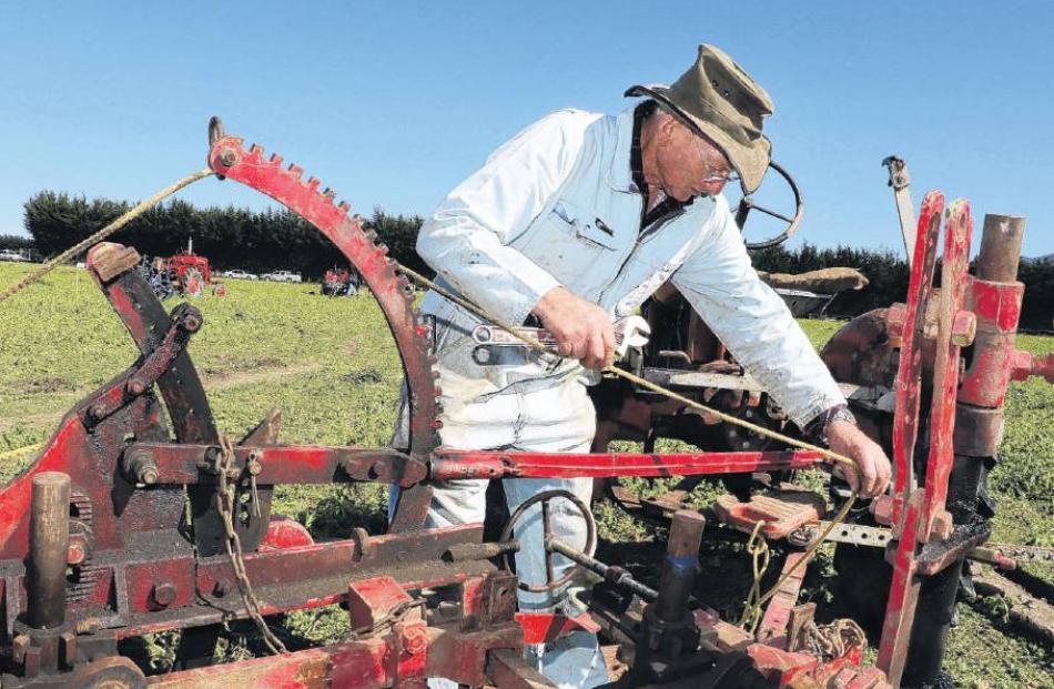 Practised touch . . . Bill Ward of Rangiora, carefully prepares his plough for his first run at...