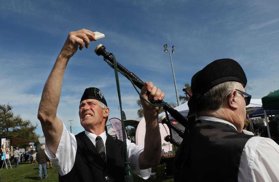 Piper Robert Forrester tunes the pipes of a member of the McAlpines North Canterbury Pipe Band at...