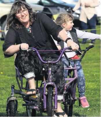 Cycling fun . . . Kerrie Watson of Belfast peddles with her daughter Ameleah Watson-Madeley 5, on...