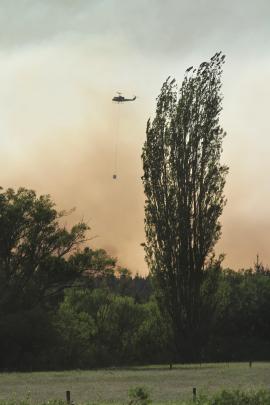 All hands on deck . . . Helicopters with monsoon buckets are fighting the large fire in the...
