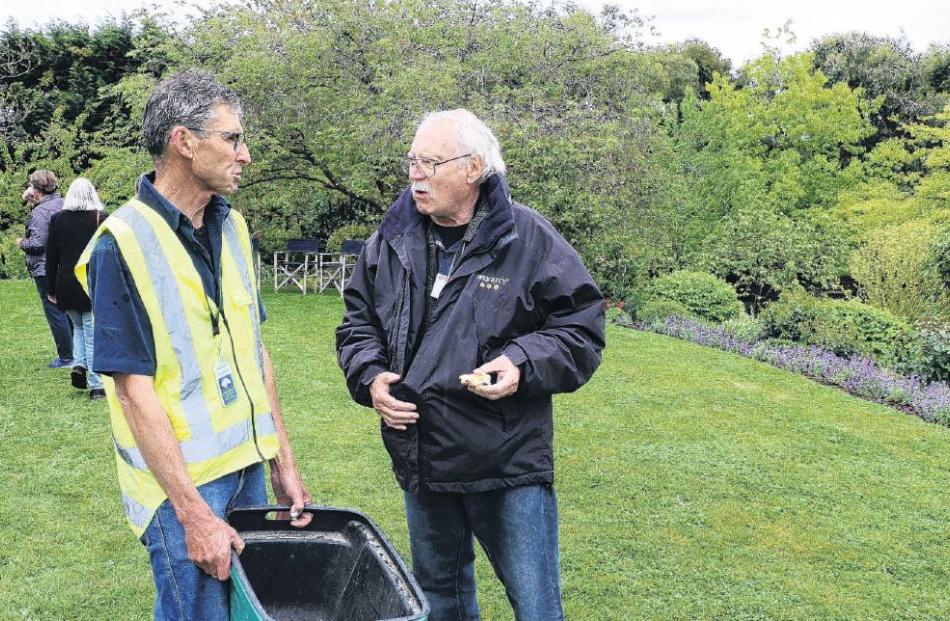 Discussing the gardening . .. Reg Williams of Christchurch, chats with owner David Hunter (left)...