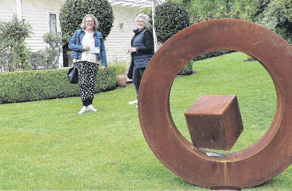 Art on show . . . Admiring the art on display in the gardens of the Karetu Downs homestead were...
