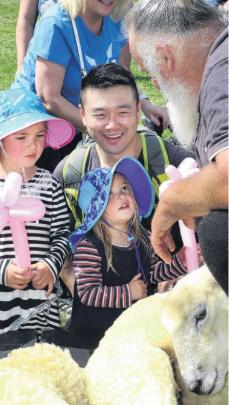 Nice wool. . . Blade shearer Richard Watson of Hawarden (right), allows Olivia 4, and Zoe 2 , and...