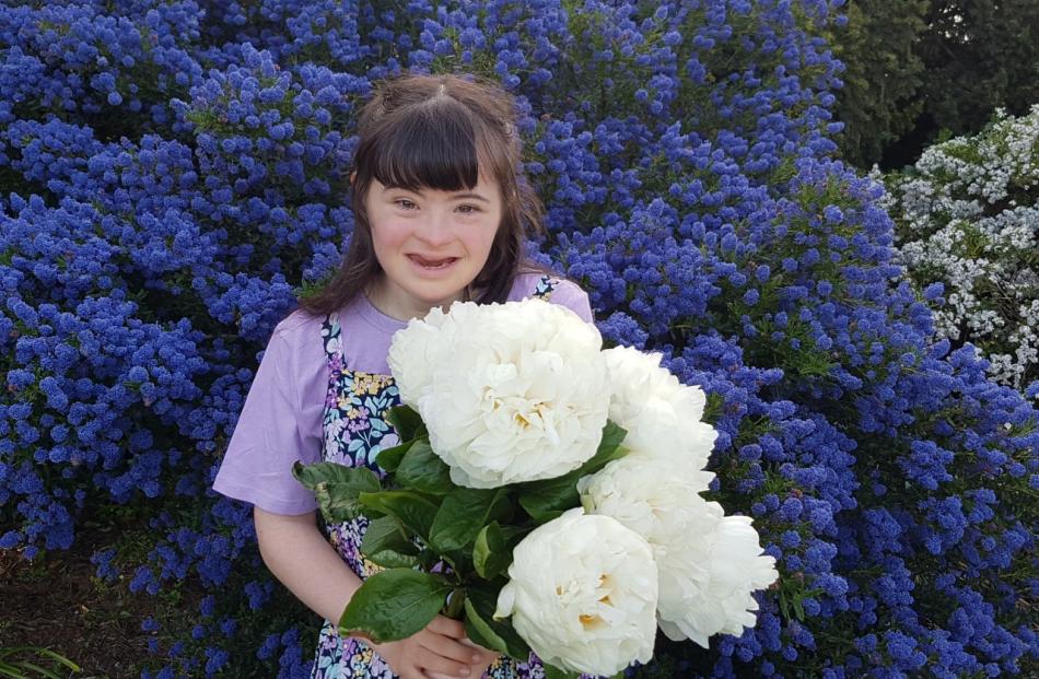 Angela Early, of Greendale, with the specially bred peonies named after her. Photo: Supplied