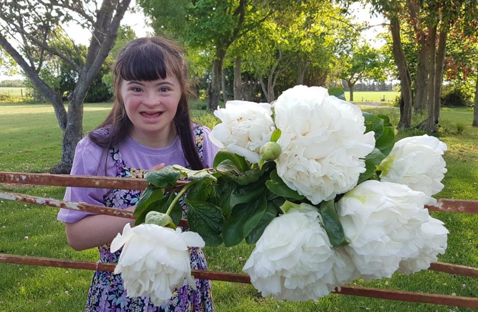 Angela Early holds some of the special flowers that have been named after her. Photo: Supplied