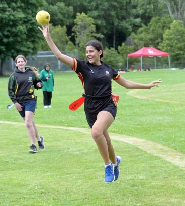 Avie Morgan (13), of Dunstan High School, throws the ki (ball) while being pursued by Ella Thom ...