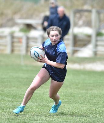 St Hilda’s rugby sevens player Zara Lunam (14) spots a gap at Kettle Park.