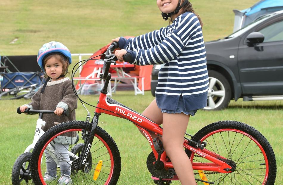 Ella (2) and Libby (7) Eynon, of Invercargill, try out their Christmas presents at the Omakau...