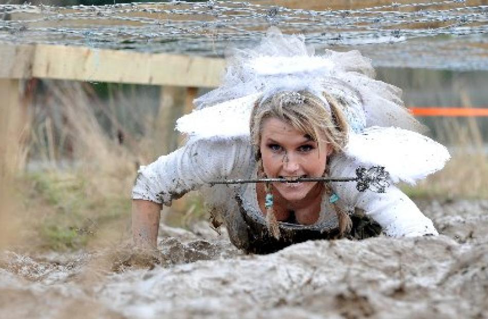 Ilona Pawlowski calls on her fairy powers to make her way under the barbed wire.