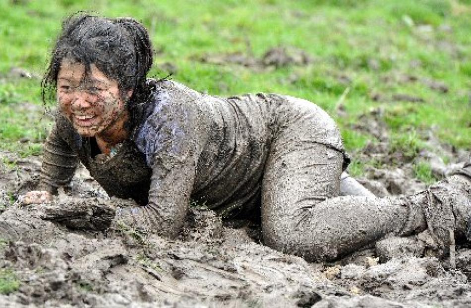 Lily Zhang takes a breather after exiting the barbed-wire challenge during yesterday's Mud, Sweat...