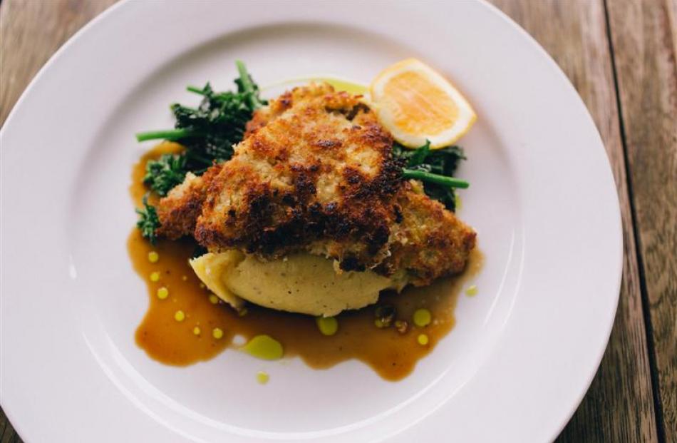 Veal schnitzel with mashed potatoes,greens and lemon.