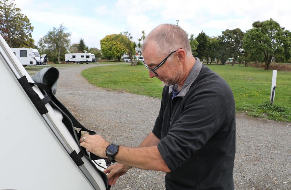 Setting up camp . . .  Andy Baker of Tauranga, sets up his caravan in the newly opened  Kaiapoi...