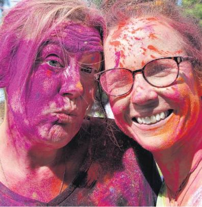 Purple haze . . . Lou Reeves (left) and Melissa Saunders enjoy the colourful fun. PHOTO: JOHN...