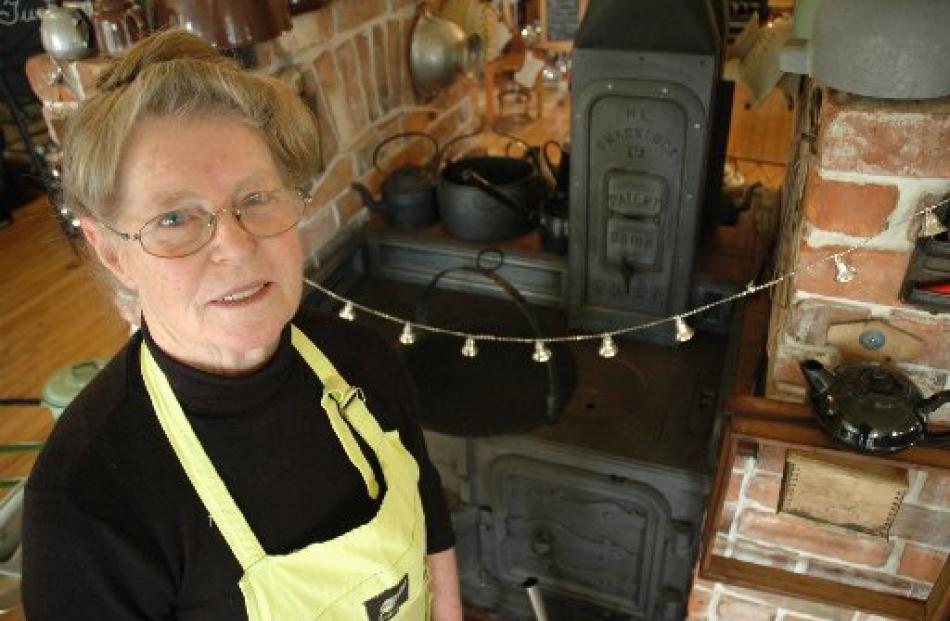 Helen McKay, of Yesteryears Museum Café, stands in front of the 1870 coal range on which she...