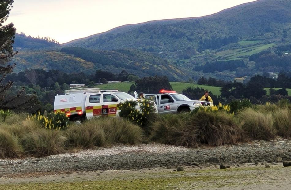 Firefighters watch from the mainland. Photo: Supplied 