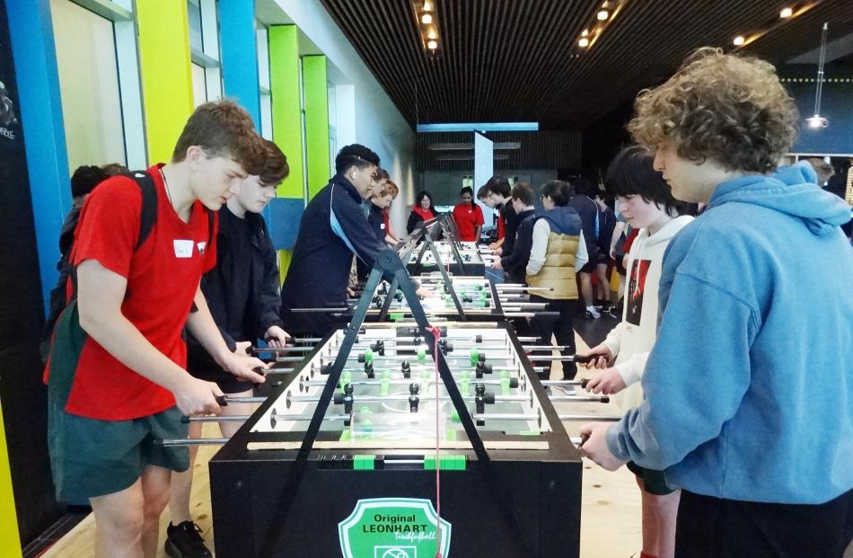 Ethan Sinclair (left, Kaikorai Valley) tries his hand at foosball.