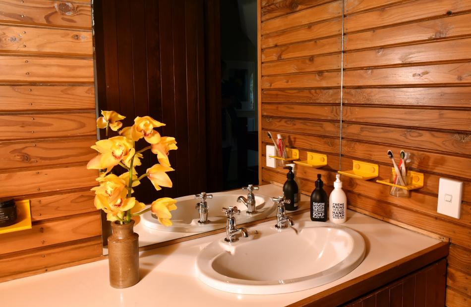 Owner Julia Hutchinson jokes that taking a bath in the timber-lined bathroom is like being in a ‘...