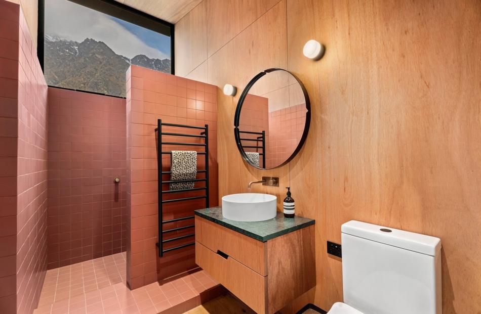 Framed views of the mountains are everywhere — even in bathrooms, where windows are positioned up...